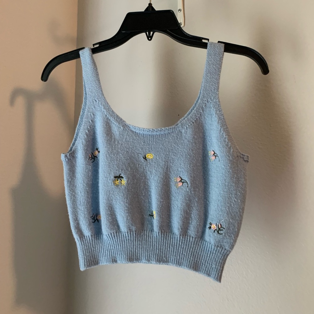 Baby blue top with flower print.